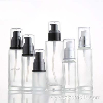 Empty round glass lotion bottle with pump